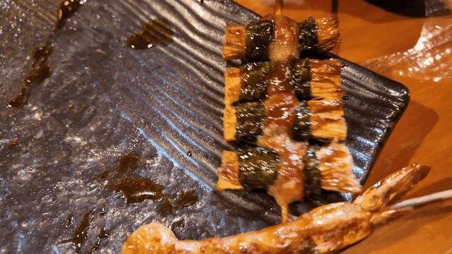 Shiitake mushroom skewers on black plate
