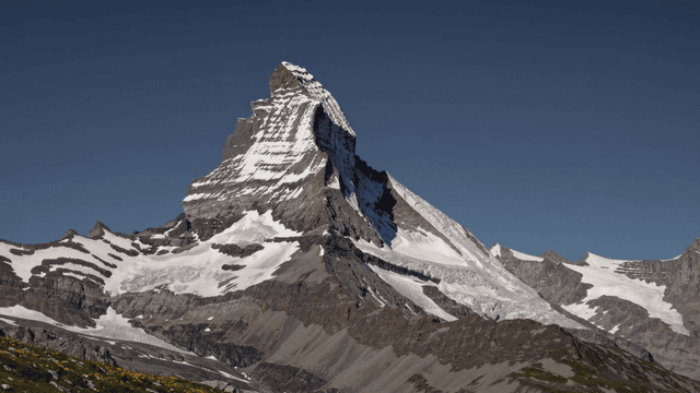 Majestic snow-covered mountains under clear sky