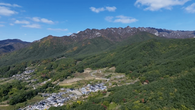 Green mountains under a clear sky
