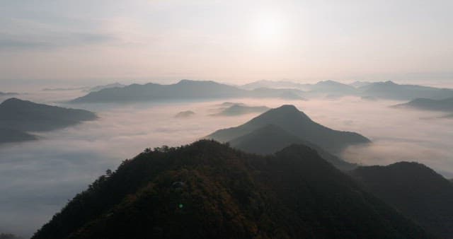 Sky Colored by Sunrise over Foggy Mountains