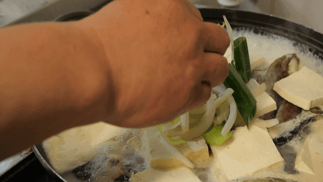 Rockfish fermented fish soup topped with tofu and vegetables