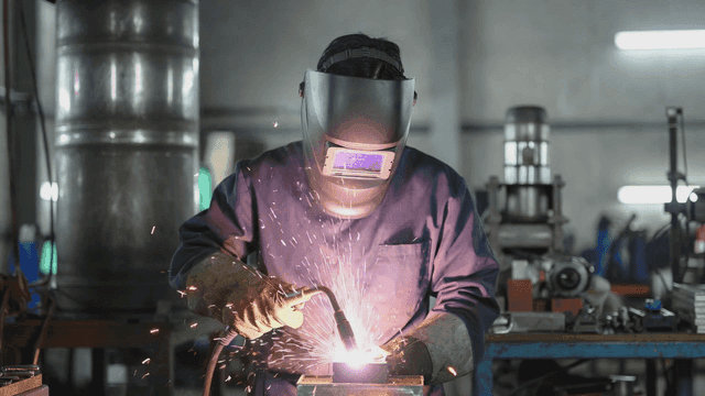 Person working on welding in factory