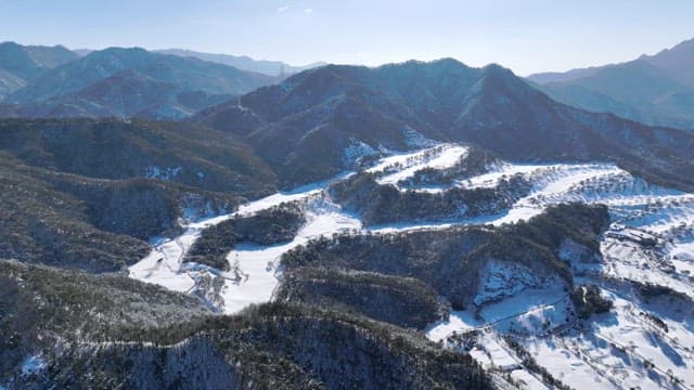 Snow-covered mountains under clear blue skies