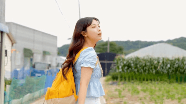 A young woman walking along a rural road