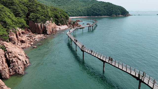 Coastal walking path with rocky cliffs