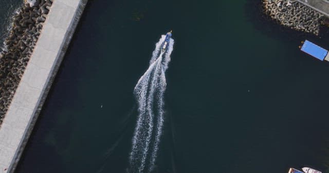 Boat sailing near a breakwater