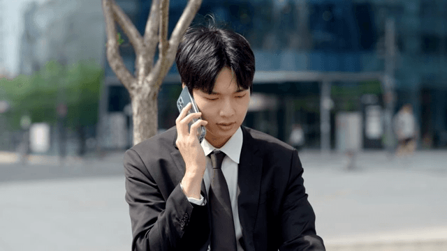 Tired office worker talking on the phone outdoors