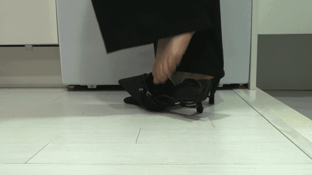 Woman's feet taking off her shoes upon entering house