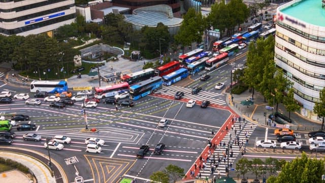 Busy city intersection throughout the day into the night