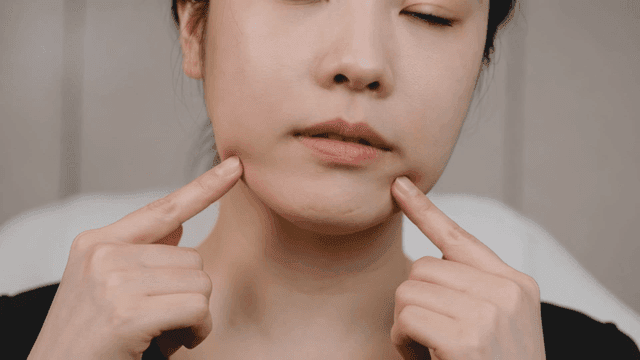 Woman touching her chin with her fingers