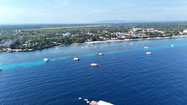 Coastal town with boats on the blue sea