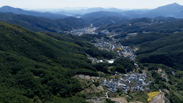 Scenic view of a village surrounded by mountains