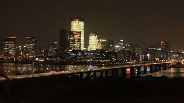 Illuminated Cityscape and River at Night