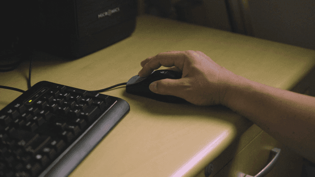 Hand using computer mouse