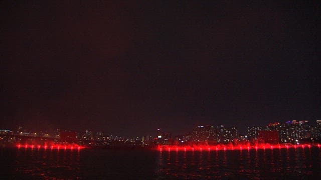 Colorful Fireworks Display Over the City Skyline and River