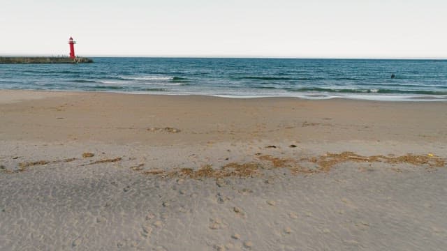 Serene Beach View with a Lighthouse