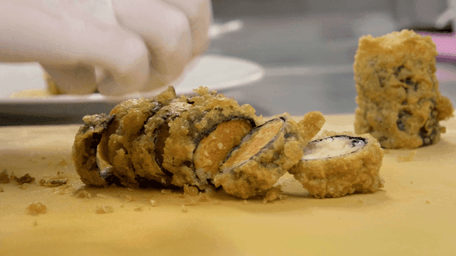 Fried sushi rolls prepared on cutting board