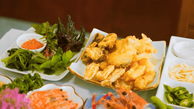 Assorted seafood dishes with fresh greens
