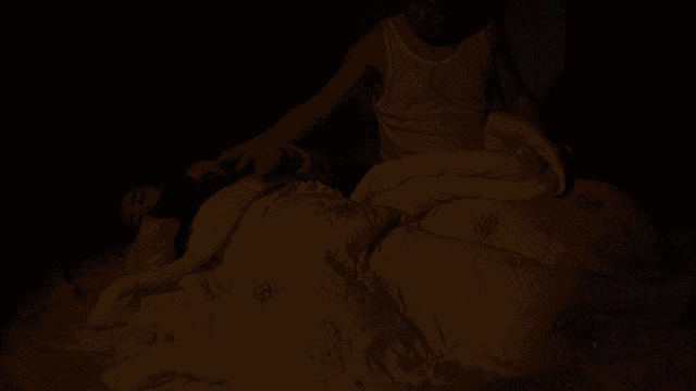 Couple sleeping peacefully under covers