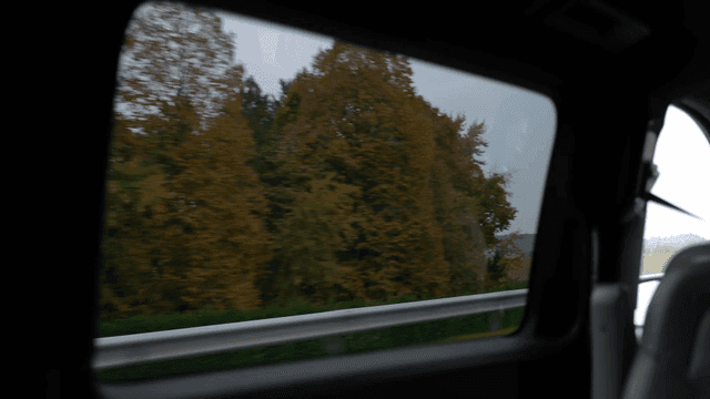 Countryside scenery seen through window of car while driving