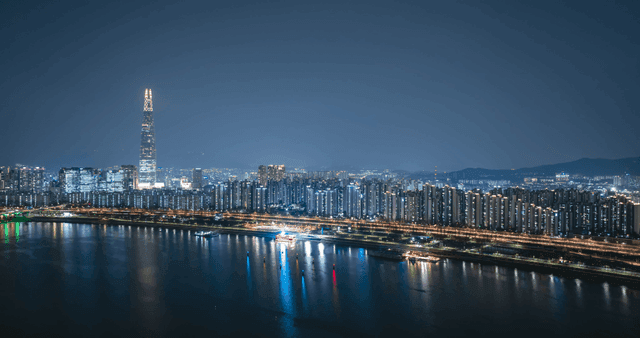Night view of a city skyline with a river