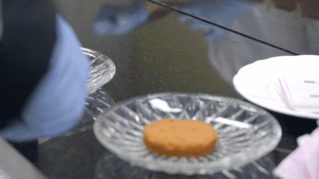 Cookies being decorated with cream