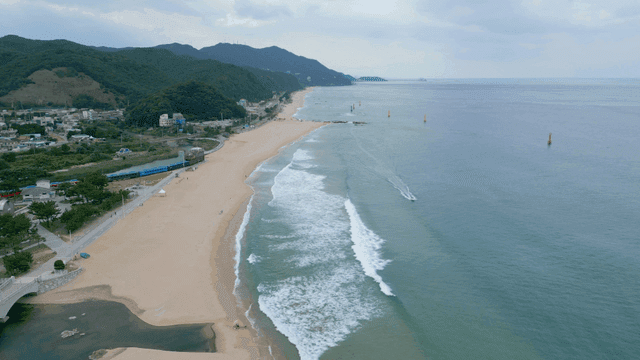 Beautiful beach with waves and train