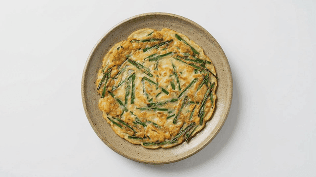 Korean pancake with green onions on a plate