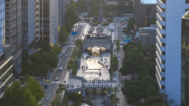 Bustling city street with a stream