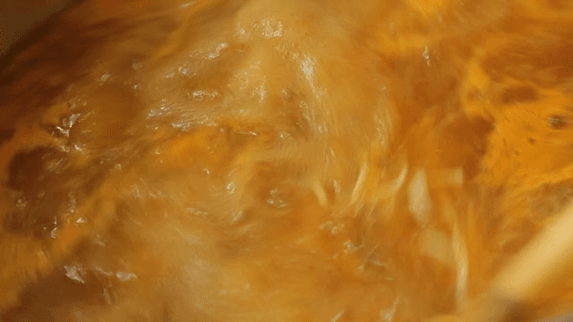 Noodles boiling in a pot with broth