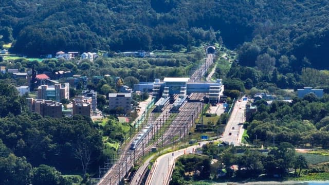 Train station surrounded by lush greenery