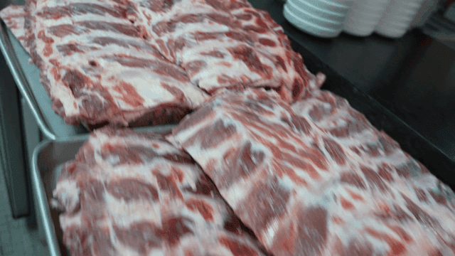 Raw beef short ribs placed on tray in kitchen