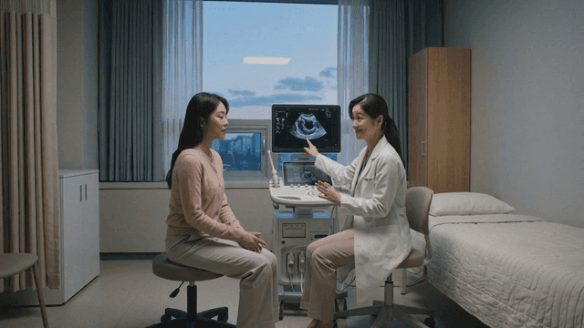 Pregnant woman receiving doctor's consultation in examination room