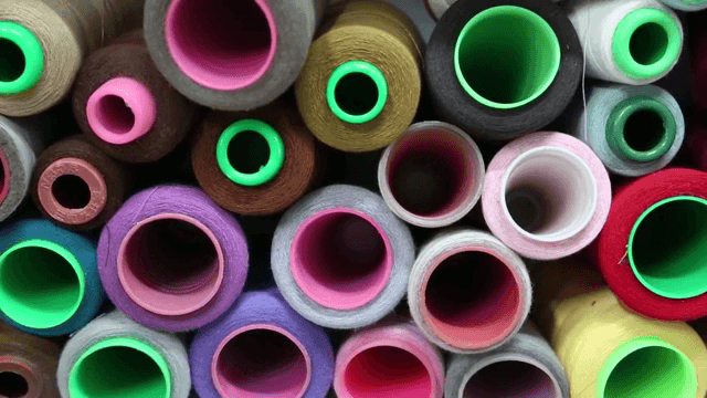 Colorful spools of thread arranged closely