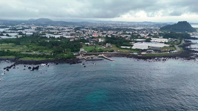 Coastal city with green landscapes and sea