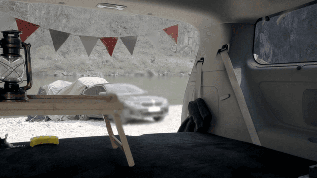 Car camping setup by a riverside