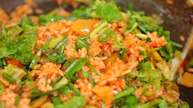 Fried Rice with Vegetables and Seaweed Powder on an Iron Plate