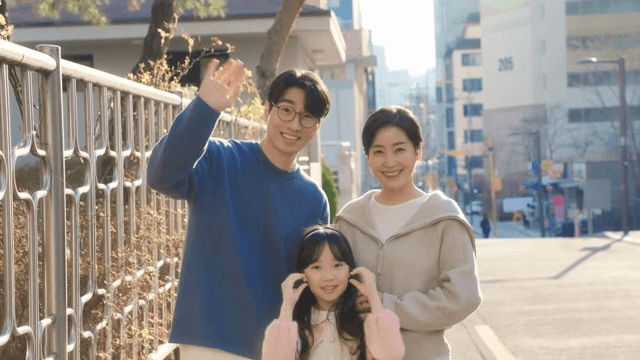 Family smiling on a sunny street