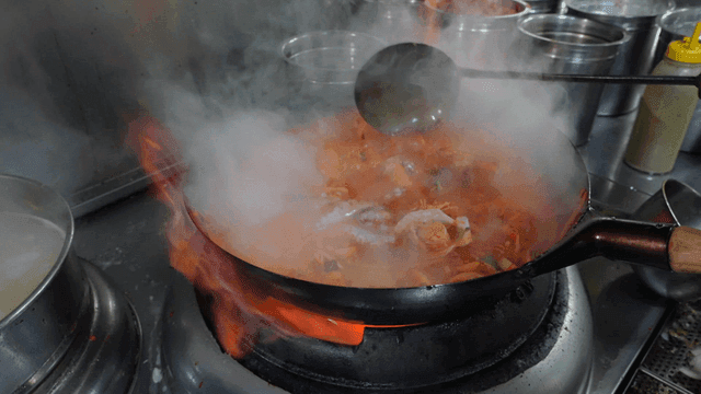 Various seafood ingredients in spicy Jjamppong boiling in wok
