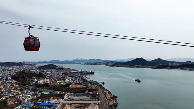 Cable cars over a coastal cityscape