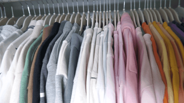 Various clothes neatly hung in a closet