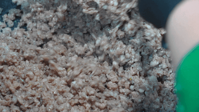 Ground meat being cooked in a pan