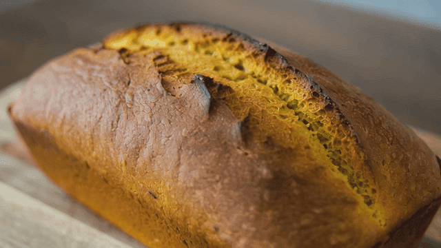 Freshly baked pound cake on wooden cutting board