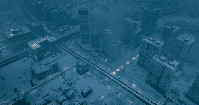 Snow-covered cityscape with tall buildings