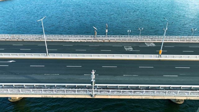 Overhead View of Vehicles on a Bridge Over Blue River