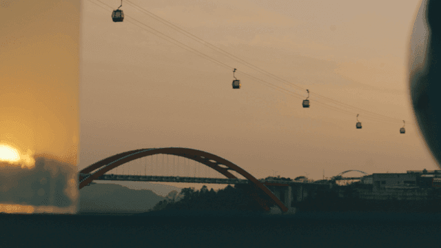 Cable car over evening bridge