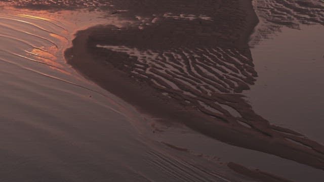 Sunset over a serene tidal flat