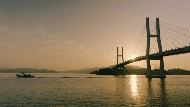Bridge and sunset over calm sea