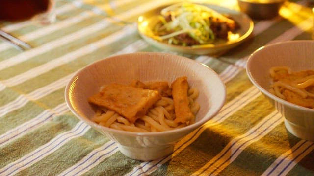 Delicious udon noodles with fish cakes served on a cozy table