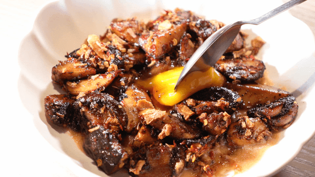 Mushroom dish where raw egg yolk bursts with spoon